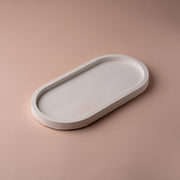 Minimalist white oval tray on a beige background, modern home decor accent piece